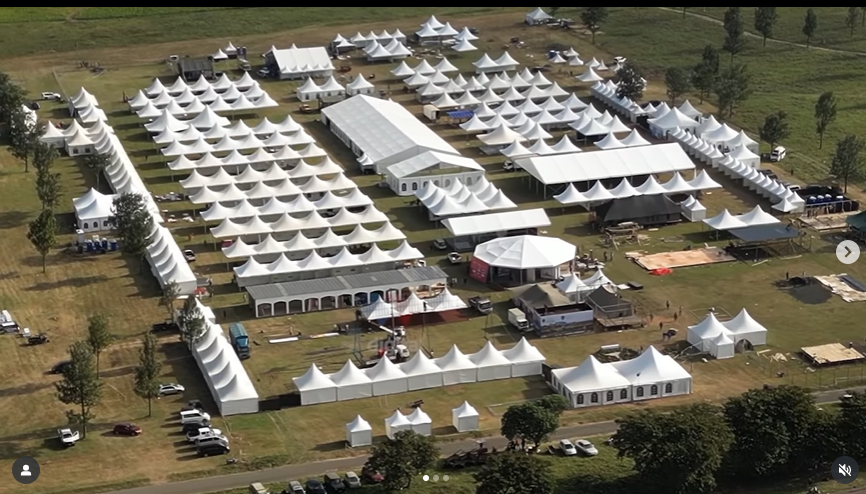 Aerial view of a large tent village with dozens of pagoda and marquee tents