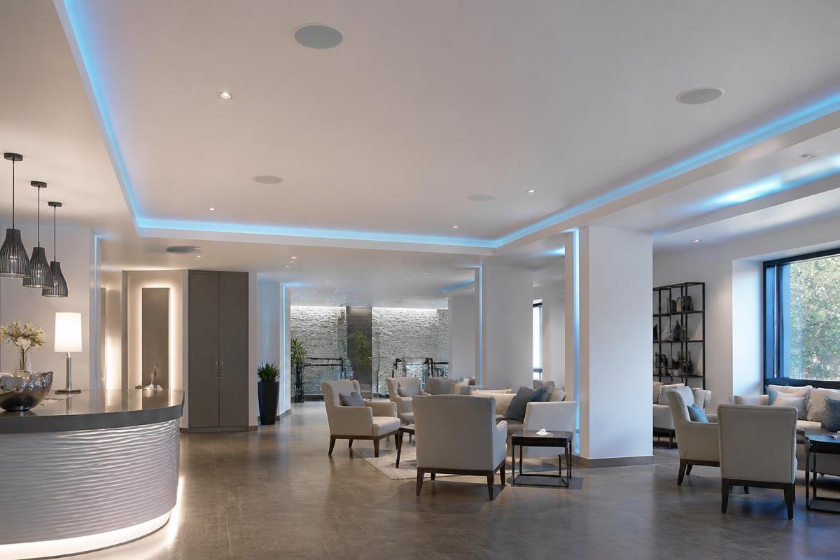 Modern commercial audio installation with ceiling speakers and ambient lighting